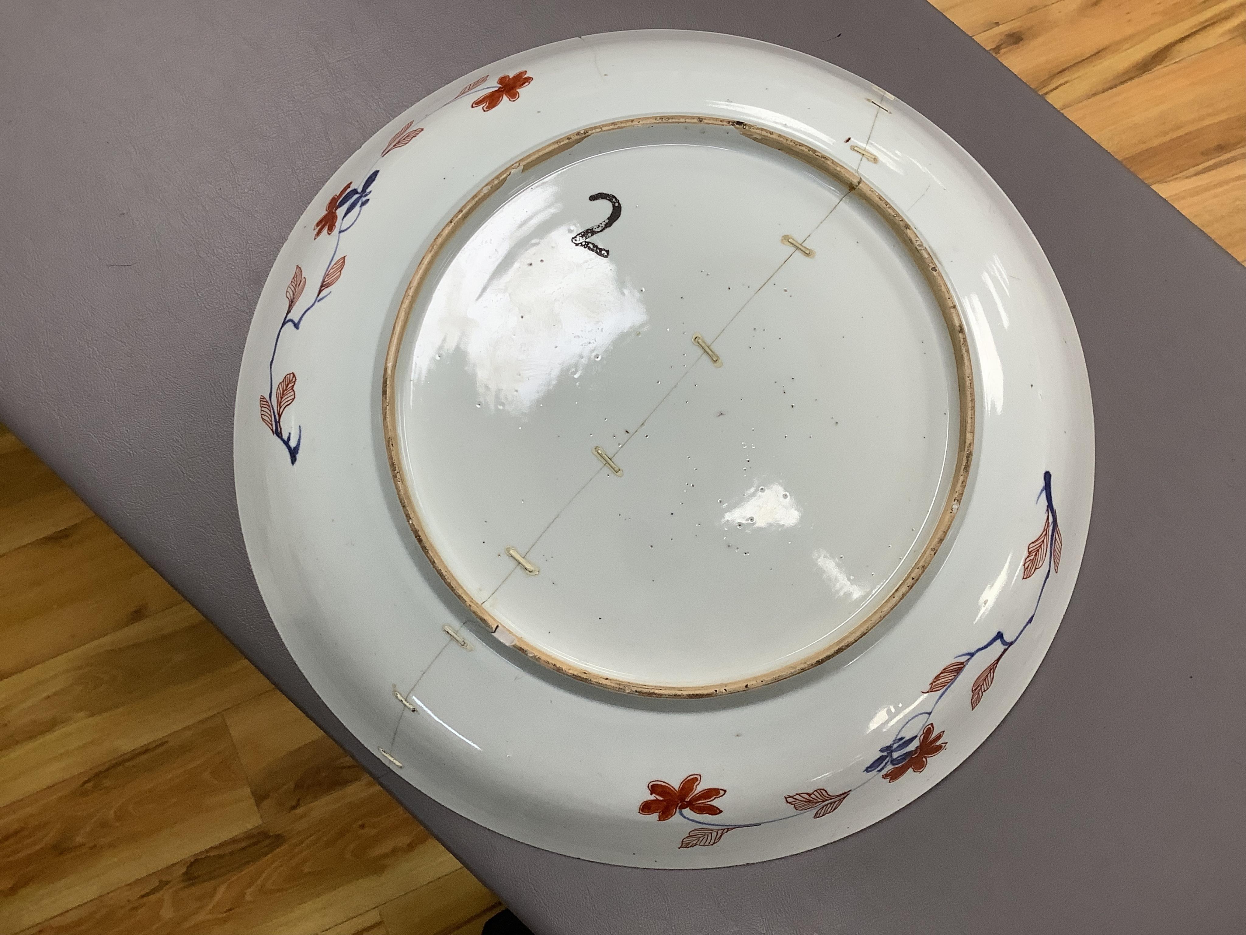 Three early 18th century Chinese Imari dishes (one clobbered), largest 46.5cm, together with a 19th century Chinese powder blue ground vase, 44cm high and a horn carving, 13.7cm (5)